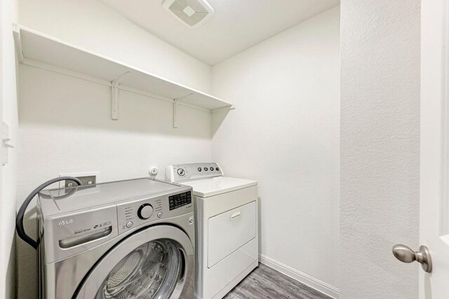 washroom featuring independent washer and dryer and dark hardwood / wood-style floors