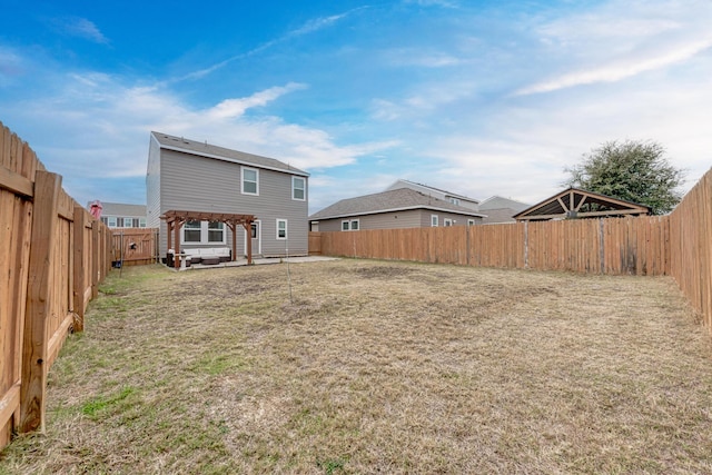 back of house with a yard and a pergola