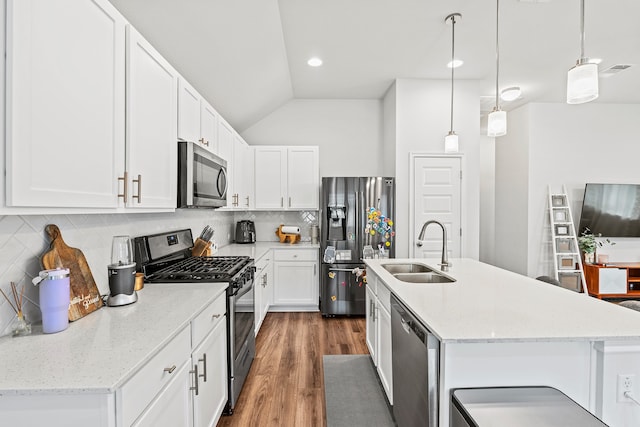 kitchen with decorative light fixtures, sink, white cabinetry, and appliances with stainless steel finishes