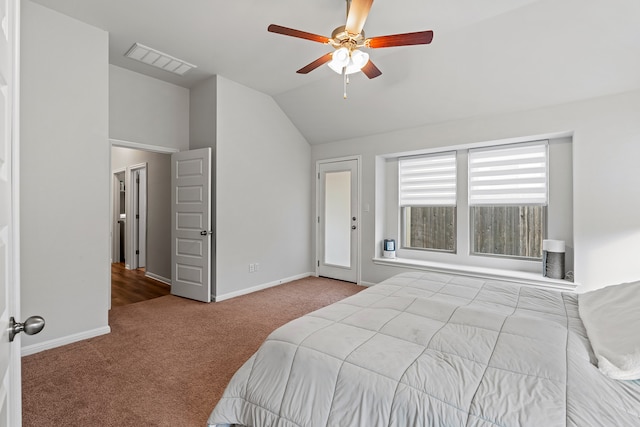 carpeted bedroom with ceiling fan and vaulted ceiling