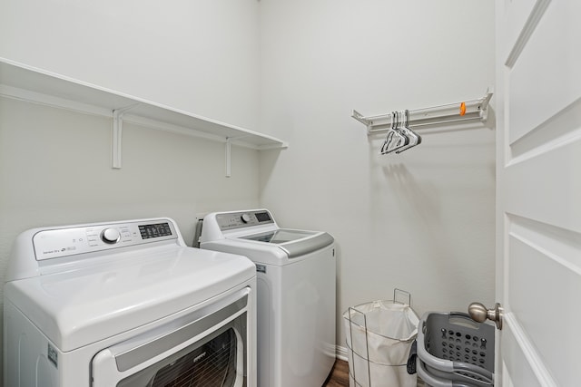 washroom featuring washer and clothes dryer and dark hardwood / wood-style flooring