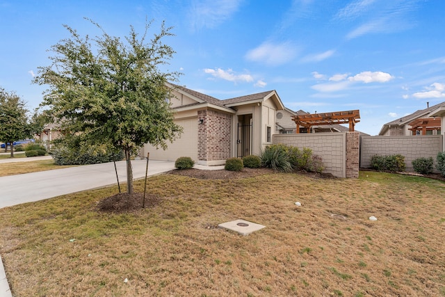 view of front of property featuring a garage, a front yard, and a pergola