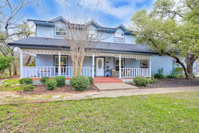 view of front of home featuring covered porch and a front yard