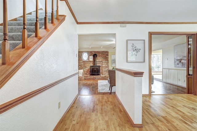 hall with hardwood / wood-style floors and crown molding