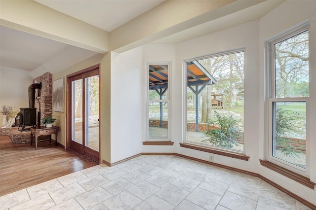 entryway featuring light tile patterned flooring and a wood stove