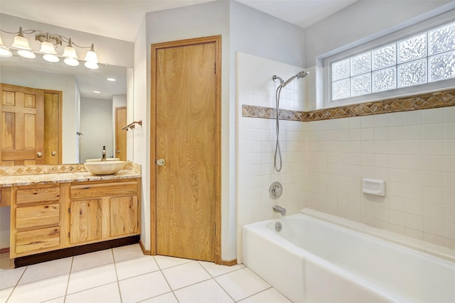 bathroom featuring tile patterned flooring, vanity, and tiled shower / bath combo