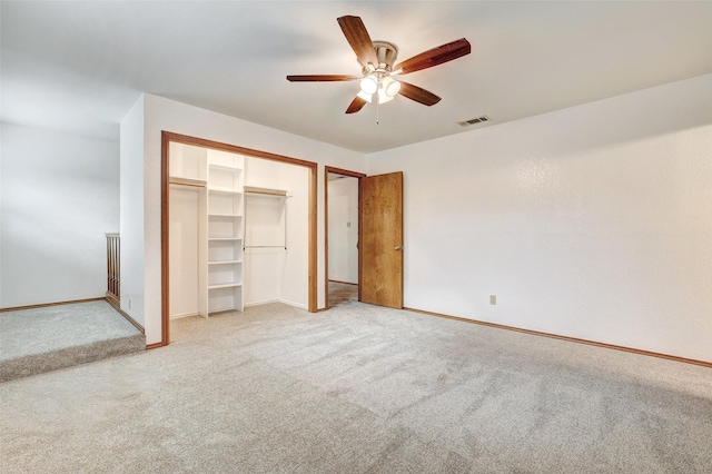 unfurnished bedroom with light colored carpet, ceiling fan, and a closet