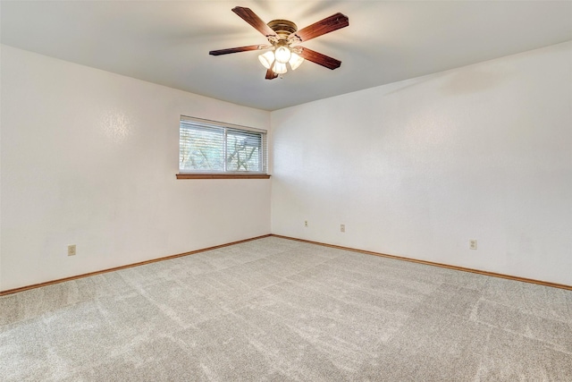 spare room with ceiling fan and light colored carpet