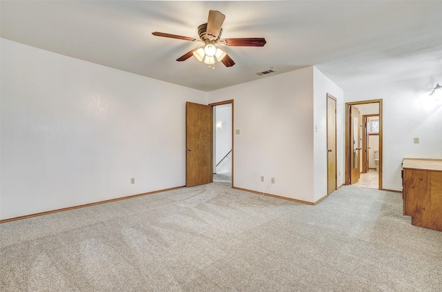 unfurnished room with light carpet and ceiling fan