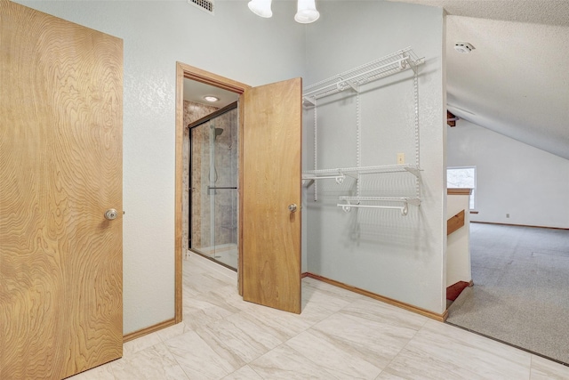 bathroom featuring lofted ceiling