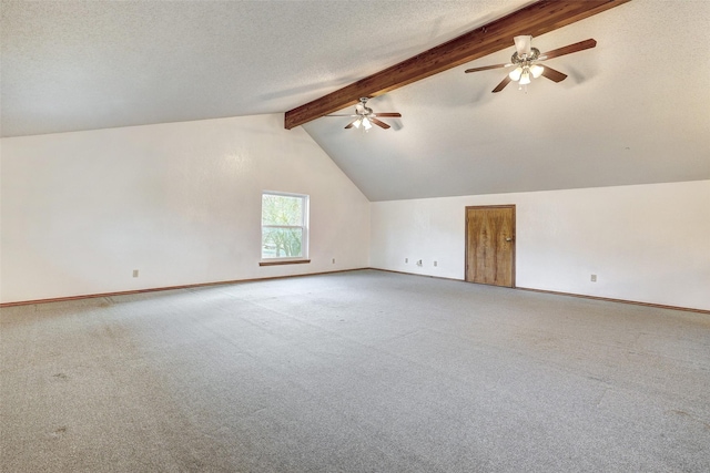 additional living space featuring carpet, vaulted ceiling with beams, and a textured ceiling