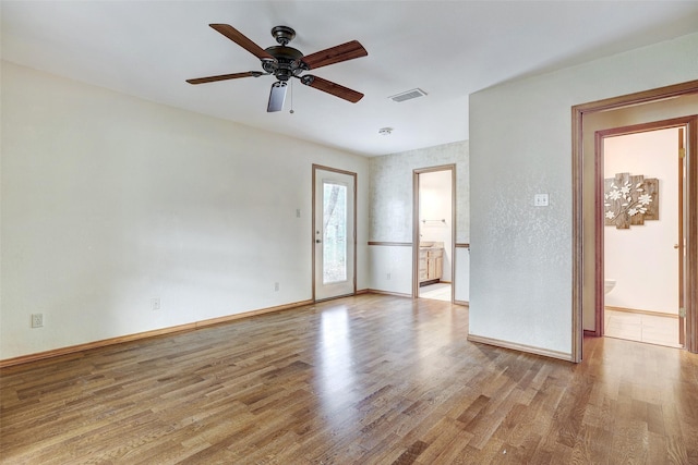 empty room with light hardwood / wood-style floors and ceiling fan