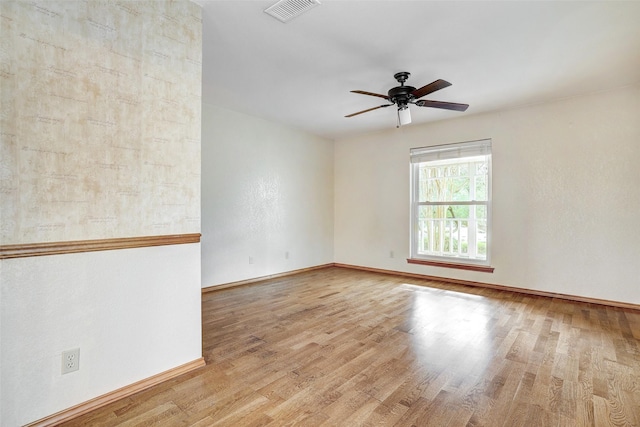 empty room with ceiling fan and light wood-type flooring