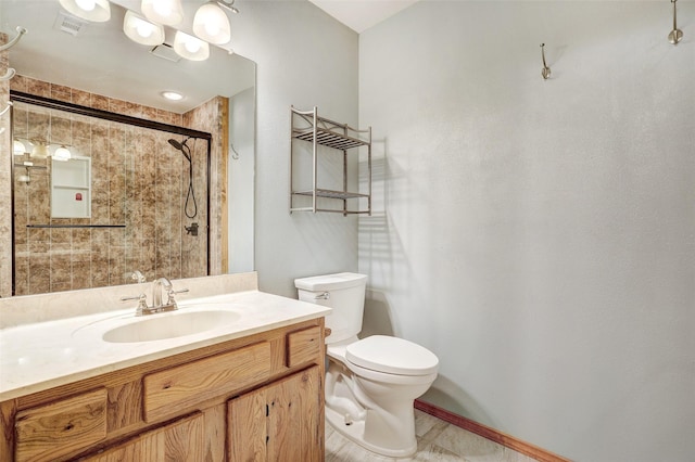 bathroom featuring vanity, an enclosed shower, and toilet