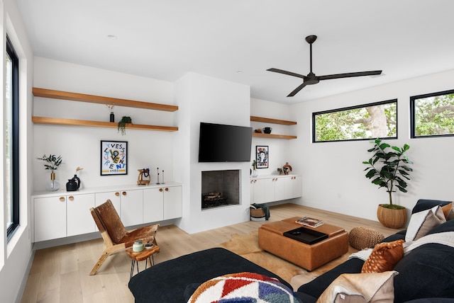 living room with light hardwood / wood-style floors and ceiling fan