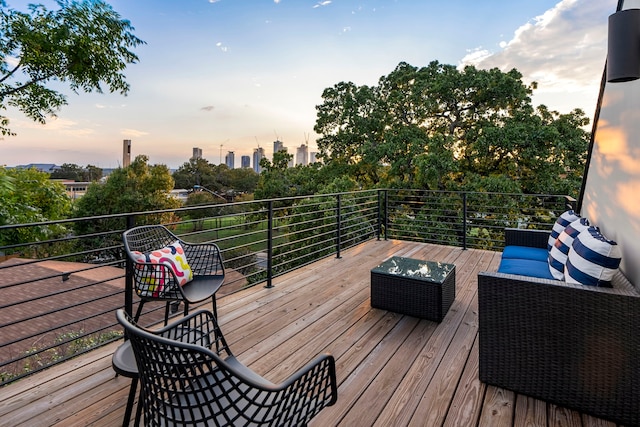 deck at dusk featuring an outdoor living space