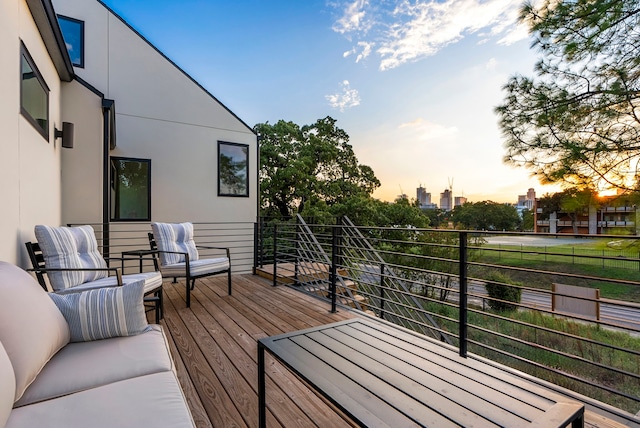 deck at dusk featuring outdoor lounge area