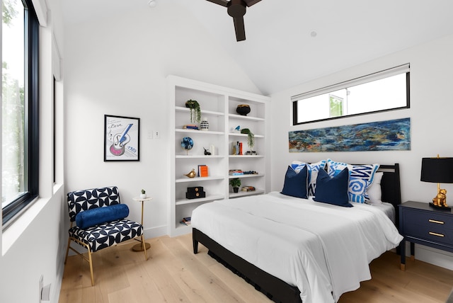 bedroom with ceiling fan, high vaulted ceiling, and light hardwood / wood-style flooring