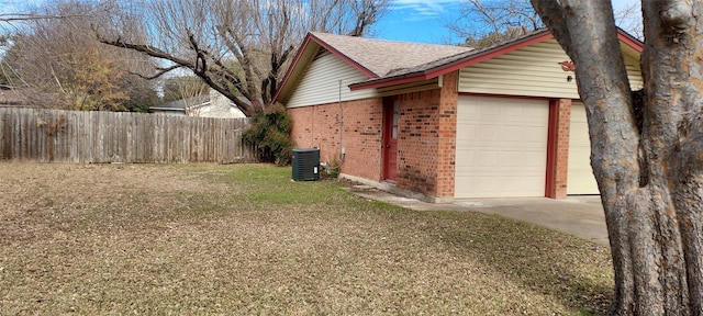 view of home's exterior with central AC unit, a garage, and a lawn