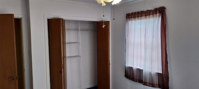 unfurnished bedroom featuring a closet and ornamental molding