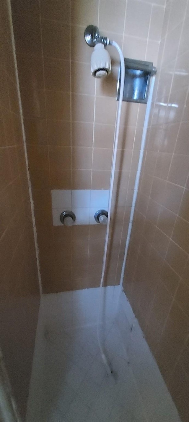 bathroom with tiled shower