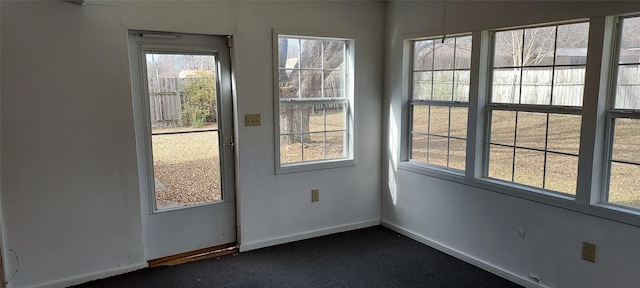 doorway featuring dark carpet