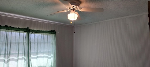 interior details with a textured ceiling, ceiling fan, and crown molding