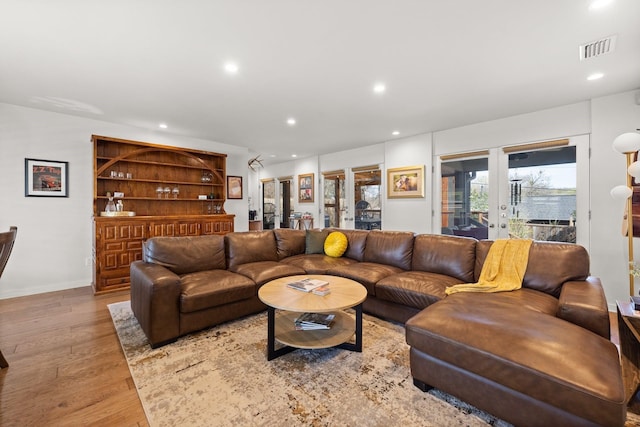 living room featuring light hardwood / wood-style floors and french doors