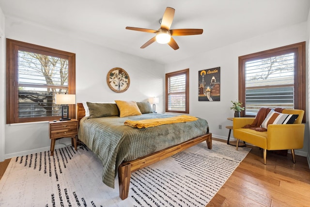 bedroom with ceiling fan and hardwood / wood-style floors