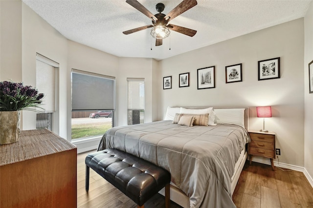 bedroom featuring ceiling fan, a textured ceiling, and hardwood / wood-style flooring