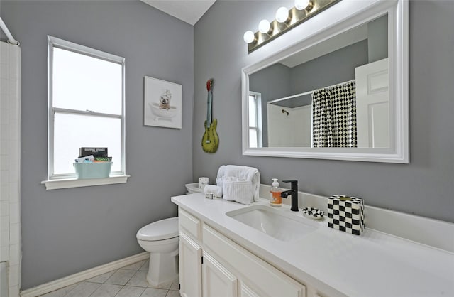 bathroom featuring toilet, a healthy amount of sunlight, vanity, and walk in shower