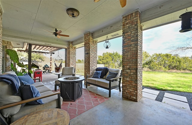 view of patio / terrace featuring ceiling fan and a fire pit