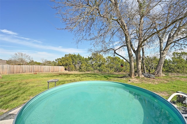 view of swimming pool with a lawn