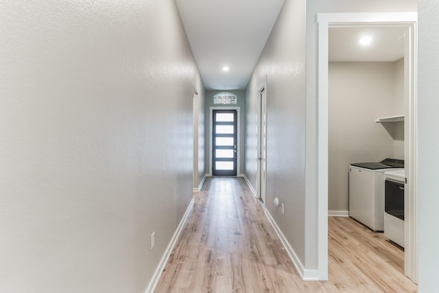 hall featuring light hardwood / wood-style floors and washing machine and clothes dryer