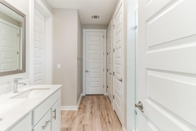 bathroom featuring vanity and wood-type flooring