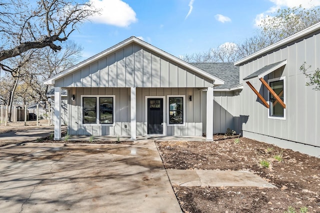 back of property featuring covered porch