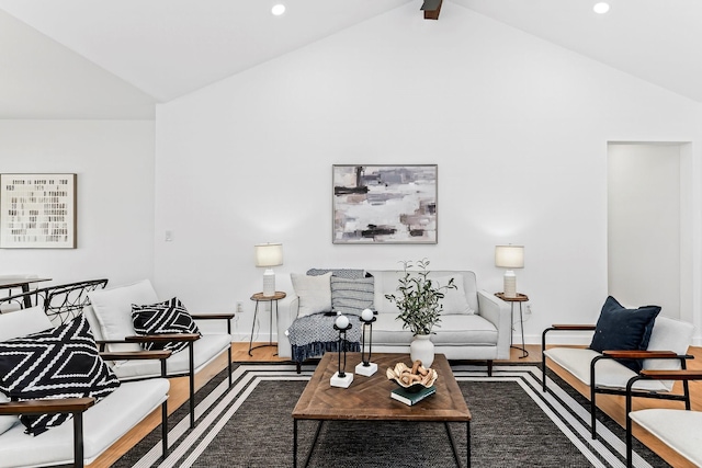 living room with vaulted ceiling with beams and hardwood / wood-style flooring