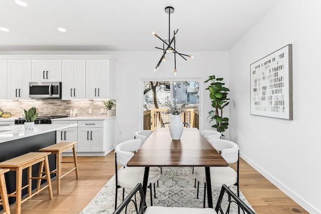 dining area featuring a chandelier and light hardwood / wood-style floors