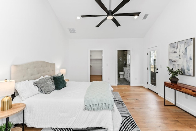 bedroom featuring a spacious closet, light hardwood / wood-style floors, access to exterior, a closet, and ceiling fan