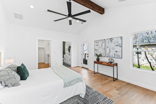 bedroom featuring ceiling fan, multiple windows, a spacious closet, and beamed ceiling