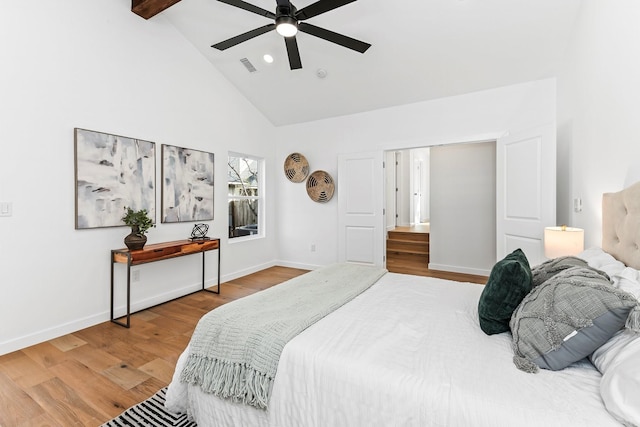 bedroom featuring ceiling fan, hardwood / wood-style flooring, high vaulted ceiling, and beamed ceiling