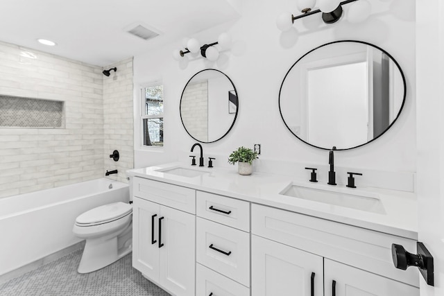 full bathroom with toilet, vanity, tiled shower / bath combo, and tile patterned flooring