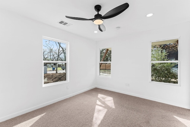 carpeted spare room with ceiling fan