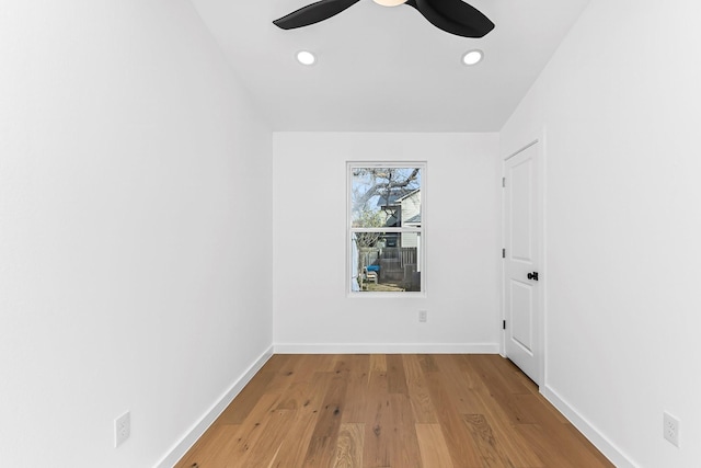 empty room with ceiling fan and hardwood / wood-style flooring