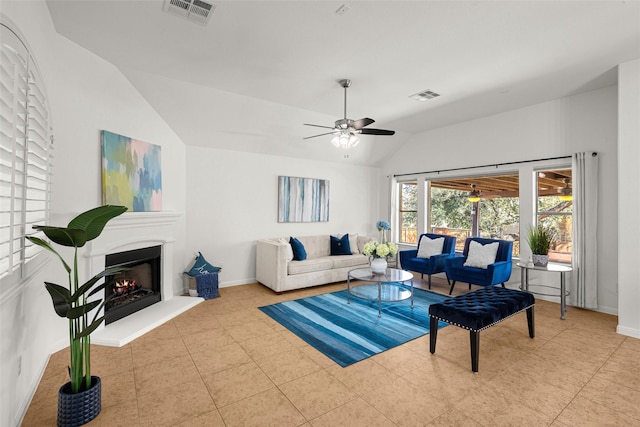 tiled living room featuring ceiling fan and vaulted ceiling