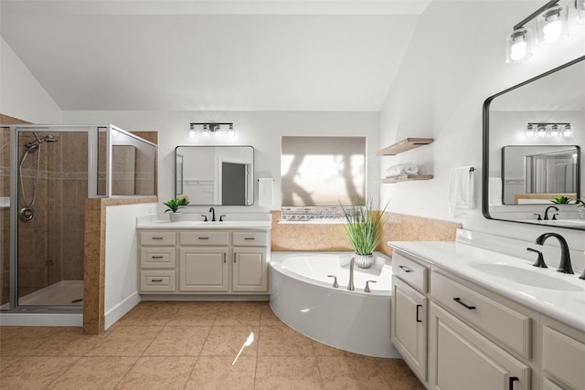 bathroom featuring vaulted ceiling, tile patterned flooring, shower with separate bathtub, and vanity