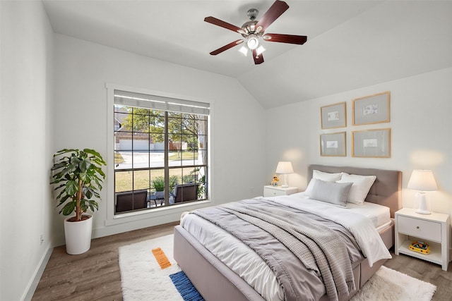 bedroom featuring ceiling fan, wood-type flooring, and vaulted ceiling