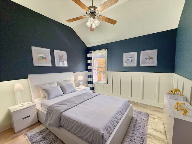 bedroom with ceiling fan, lofted ceiling, and light hardwood / wood-style flooring