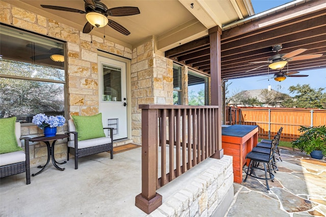 view of patio featuring ceiling fan and an outdoor bar