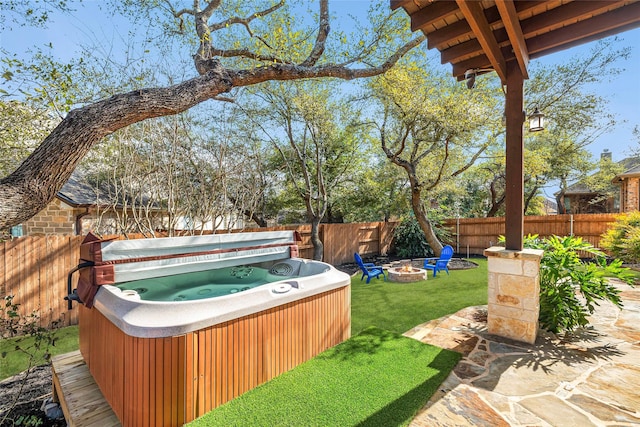 view of yard with a hot tub and a fire pit